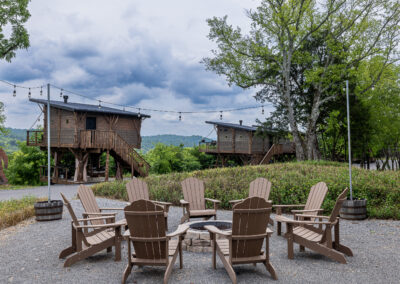 Firepit prominent and treehouses in the back