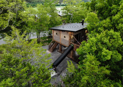 Treehouse with slides in the trees.