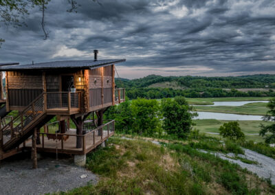 Treehouse overlooking field with stunning clouds