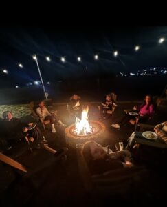 Kids enjoying Outdoor firepit ringed with Adirondack chairs at Sanctuary Treehouse Resort