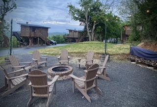 Communal firepit and treehouses at Sanctuary Treehouse Resort, a favorite for families looking for things to do in Pigeon Forge with kids