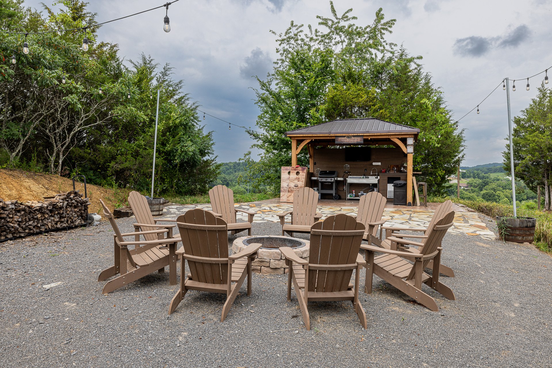 Basecamp: the covered community outdoor kitchen and firepit at Sanctuary Treehouse Resort