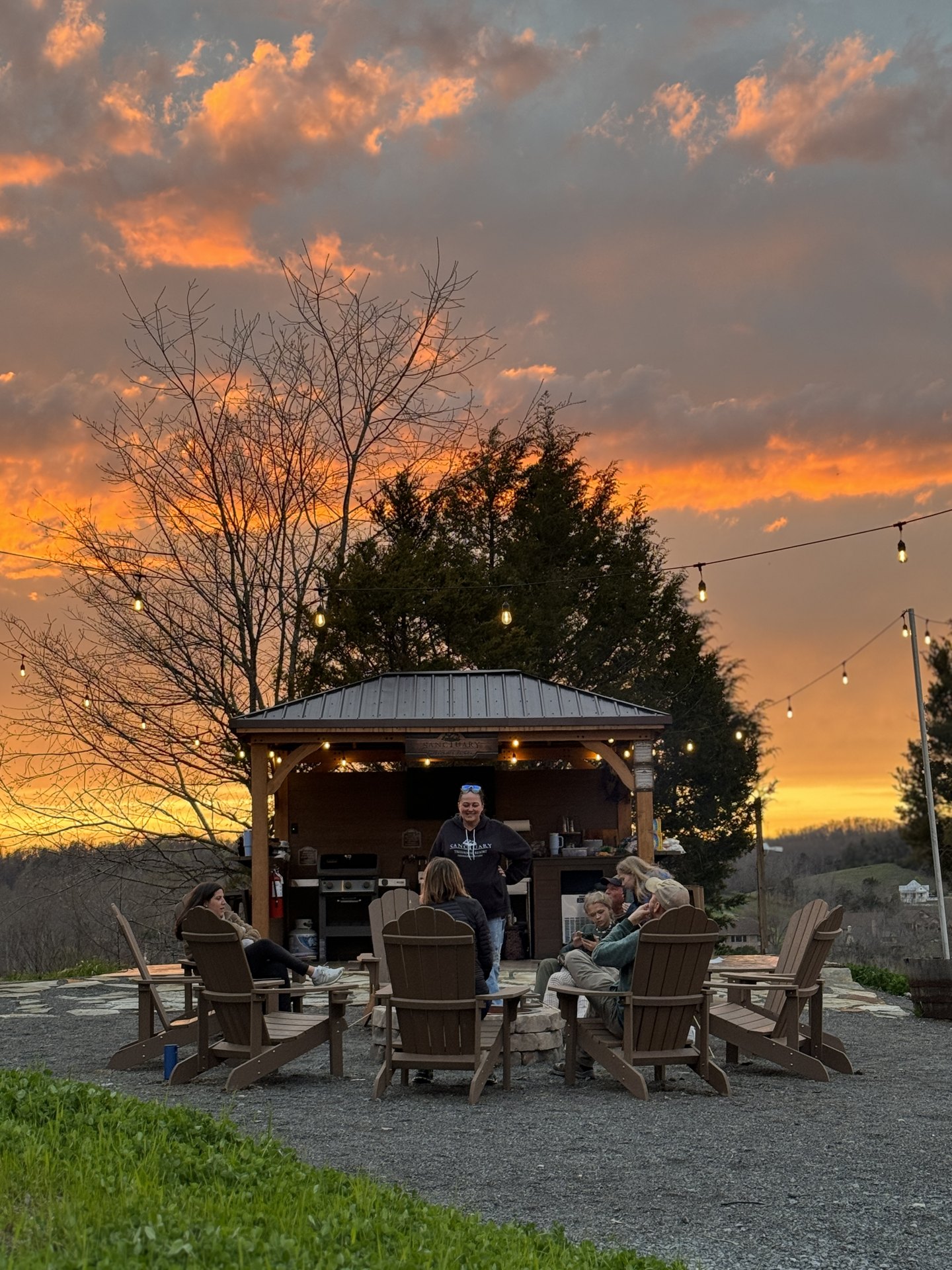 Guests gathered around the Basecamp firepit at sunset Guests gathered around the Basecamp firepit at sunset