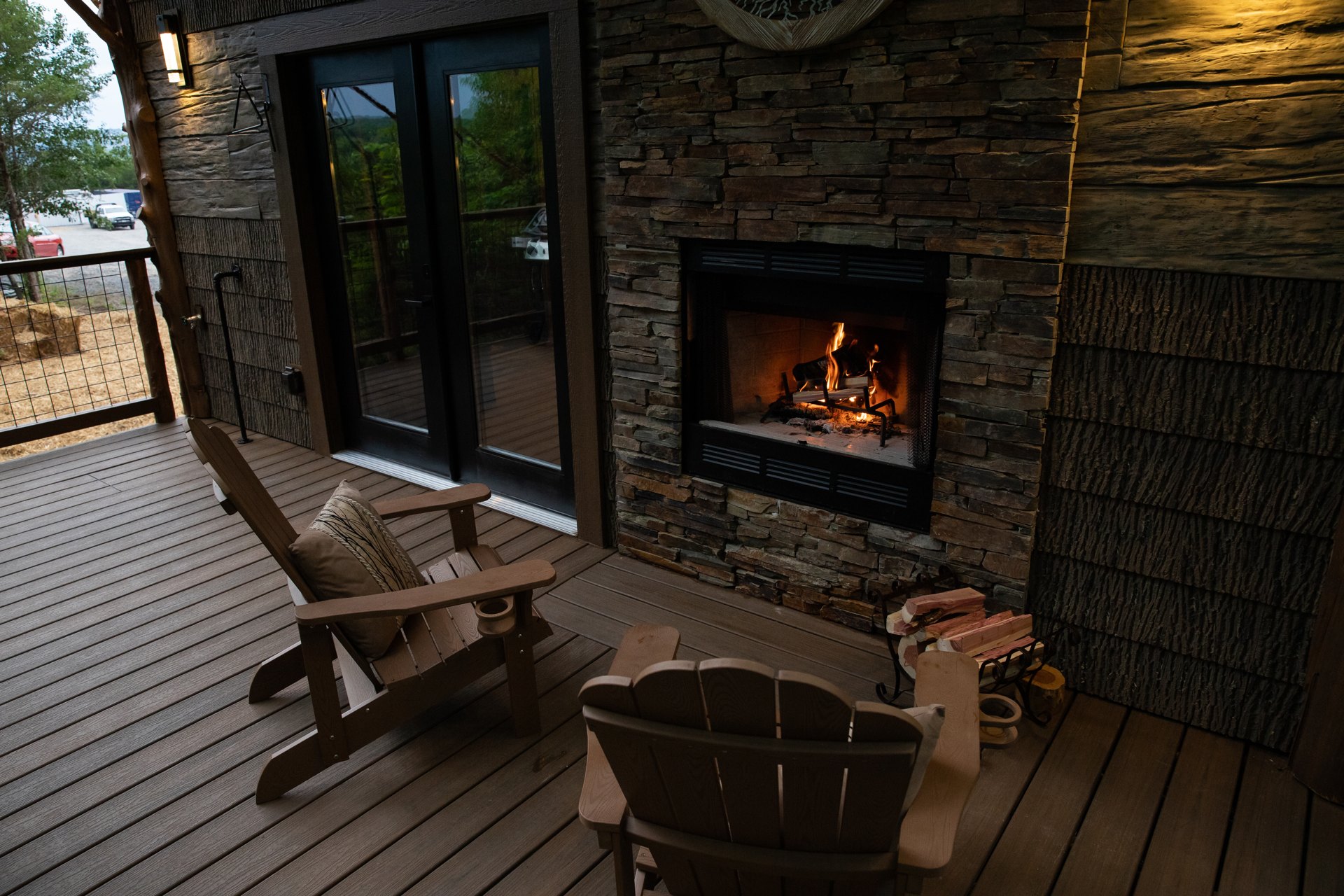 Wood-burning outdoor fireplace on a Sanctuary treehouse deck, ready for a cool fall evening