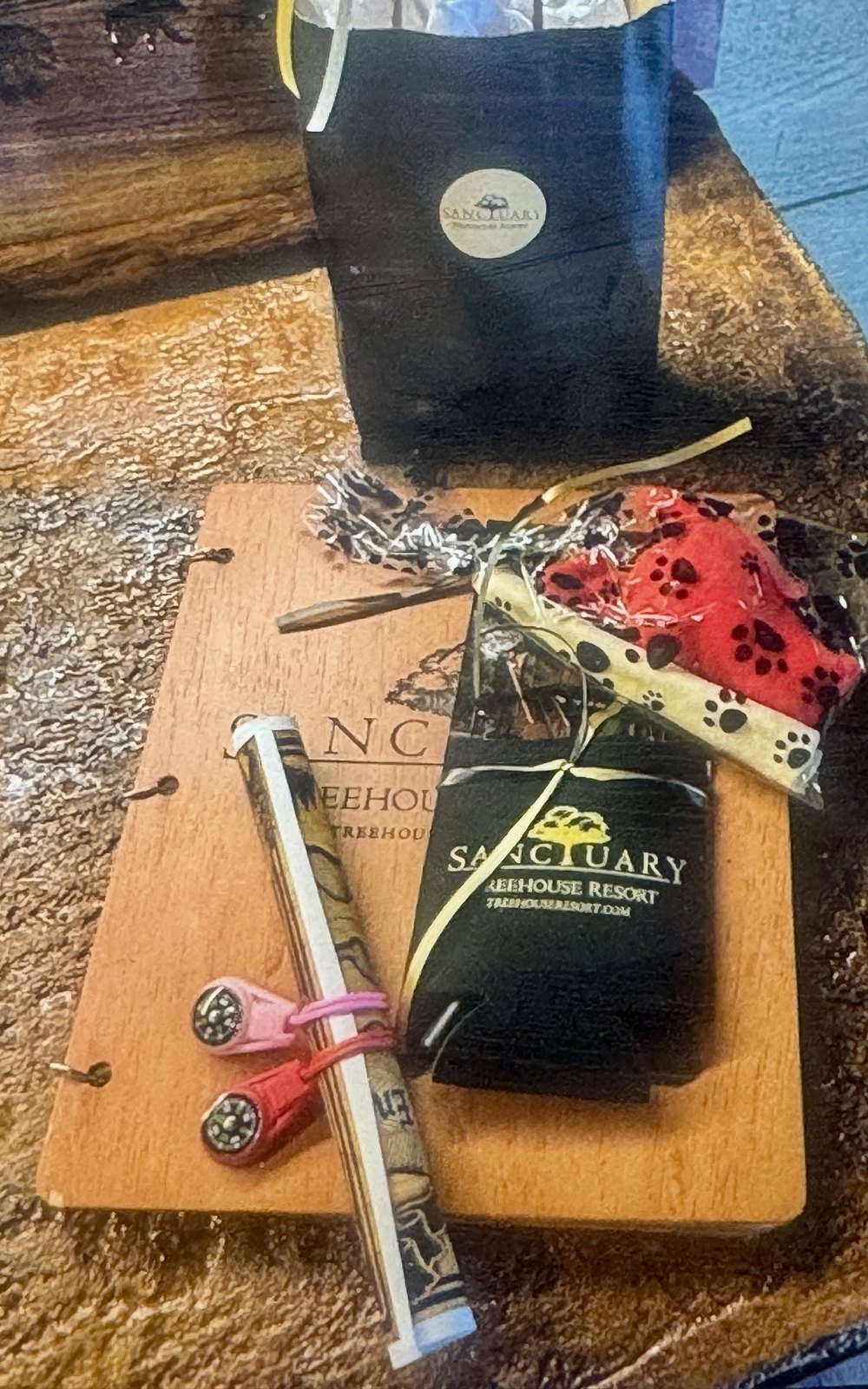 The check-in packet waiting in the treehouse, with the bandana, treats and bone that welcome every dog