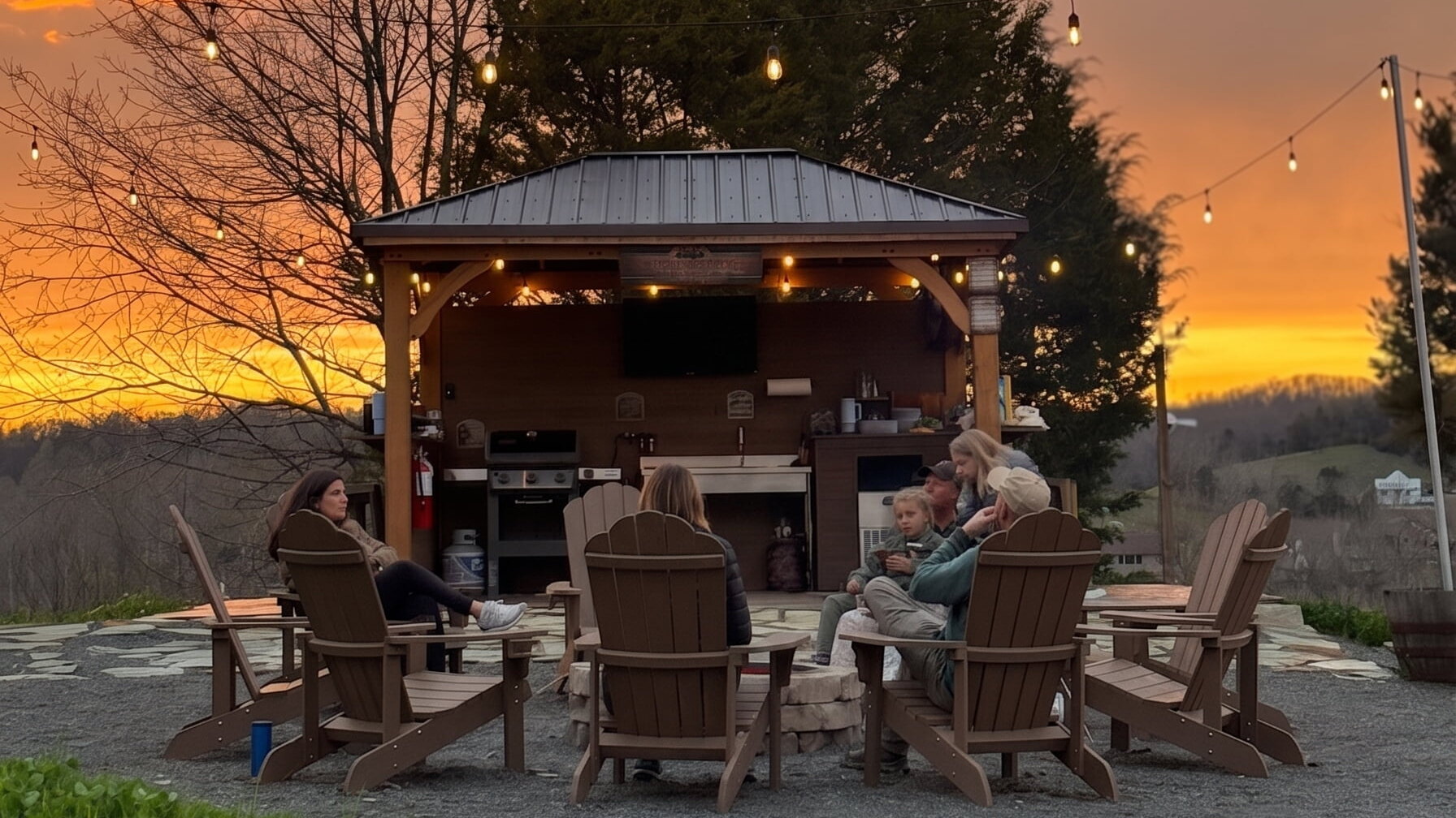Outdoor Kitchen Sunset Sky The outdoor community kitchen and firepit under a sunset sky